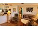 Living room with leather recliner, couch, and partial kitchen view at 745 Coral Way, Englewood, FL 34223
