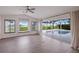 Bright living area with sliding glass doors opening to the pool and golf course views at 495 Coral Creek Dr, Placida, FL 33946