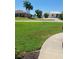 Grass yard with walkway to house at 495 Coral Creek Dr, Placida, FL 33946