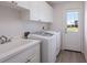 Bright laundry room with washer, dryer, sink, and ample cabinet space at 495 Coral Creek Dr, Placida, FL 33946