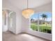 Bright dining room with chandelier and view to backyard at 495 Coral Creek Dr, Placida, FL 33946