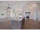 Open concept kitchen with island, stainless steel appliances, and white cabinetry at 495 Coral Creek Dr, Placida, FL 33946