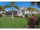 White house with tropical landscaping at 495 Coral Creek Dr, Placida, FL 33946