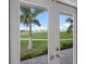 French doors open to a scenic view of the golf course and palm trees at 495 Coral Creek Dr, Placida, FL 33946