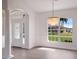 Bright dining room with chandelier and view to backyard at 495 Coral Creek Dr, Placida, FL 33946