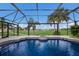 Screened pool and spa with a gorgeous golf course view at 495 Coral Creek Dr, Placida, FL 33946