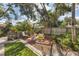 Charming backyard with wood playset and sitting area at 7192 N Paragon Rd, North Port, FL 34291