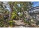 Landscaped backyard with a pathway leading to the patio at 7192 N Paragon Rd, North Port, FL 34291