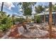 Fire pit area in backyard with brick pavers and seating at 7192 N Paragon Rd, North Port, FL 34291