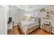 Bright bedroom featuring hardwood floors and a wood bed frame at 7192 N Paragon Rd, North Port, FL 34291