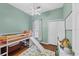 bedroom with a bunk bed, light green walls, and a ceiling fan at 7192 N Paragon Rd, North Port, FL 34291