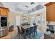 Bright dining area with a wood table and gray chairs, featuring a stylish light fixture at 7192 N Paragon Rd, North Port, FL 34291