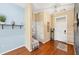 Bright and airy entryway with wood floors, built-in bench, and access to laundry at 7192 N Paragon Rd, North Port, FL 34291