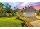 House exterior featuring a landscaped lawn, paver driveway, and two-car garage at 7192 N Paragon Rd, North Port, FL 34291