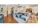 Open living area with hardwood floors, large sectional sofa, and views to kitchen at 7192 N Paragon Rd, North Port, FL 34291