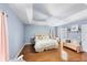 Spacious main bedroom with a king-size bed and light blue walls, hardwood floors and ceiling fan at 7192 N Paragon Rd, North Port, FL 34291