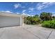 Attached garage with light gray doors and ample driveway space at 120 Barracuda Dr, Placida, FL 33946