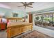 Main bedroom with king bed, wood furniture, and sliding doors to patio at 120 Barracuda Dr, Placida, FL 33946