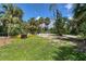 Landscaped backyard with lush tropical plants and open space at 120 Barracuda Dr, Placida, FL 33946