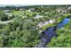 An aerial view showcasing a waterfront property with lush landscaping and a private dock at 120 Barracuda Dr, Placida, FL 33946