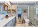 Bathroom with dual sinks, shower, and updated vanity at 120 Barracuda Dr, Placida, FL 33946