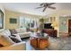 Living room featuring a large sectional sofa, tiled floors, and a ceiling fan at 120 Barracuda Dr, Placida, FL 33946