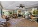 Bright and airy screened porch with wicker furniture at 120 Barracuda Dr, Placida, FL 33946
