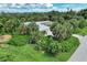 Single-story home with a large yard, lush landscaping, and solar panels at 120 Barracuda Dr, Placida, FL 33946