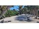 Relaxing backyard with palm trees, patio furniture, and waterfront views at 120 Barracuda Dr, Placida, FL 33946