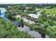 Aerial view of single-story home with waterfront access and lush landscaping at 120 Barracuda Dr, Placida, FL 33946