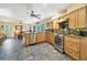 Open kitchen with island, stainless steel appliances, and view to dining area at 120 Barracuda Dr, Placida, FL 33946
