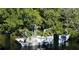 Three people on a boat fishing in a canal at 120 Barracuda Dr, Placida, FL 33946
