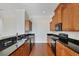 Kitchen with dark granite countertops and wood cabinets at 11708 Anglers Club Dr # 125, Placida, FL 33946