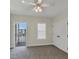 Bright bedroom with ceiling fan, neutral decor, and private balcony access at 11708 Anglers Club Dr # 125, Placida, FL 33946