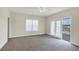 Spacious bedroom with carpeting, neutral walls, and access to balcony at 11708 Anglers Club Dr # 125, Placida, FL 33946