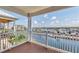 Relaxing balcony with wooden deck and railing, overlooking marina at 11708 Anglers Club Dr # 125, Placida, FL 33946