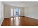 Main bedroom with hardwood floors and access to balcony and water views at 11708 Anglers Club Dr # 125, Placida, FL 33946