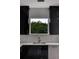 Modern kitchen with black cabinetry, quartz countertops, and stainless steel appliances at 118 Green Pine Park, Rotonda West, FL 33947
