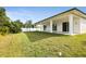 House exterior showcasing a large backyard and covered patio at 118 Green Pine Park, Rotonda West, FL 33947