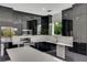 Modern kitchen with black cabinets and white countertops at 118 Green Pine Park, Rotonda West, FL 33947