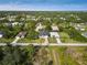 Aerial view of a house and surrounding neighborhood, showcasing the property's location and landscape at 118 Green Pine Park, Rotonda West, FL 33947