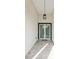 Bright entryway with double glass doors and pendant light at 118 Green Pine Park, Rotonda West, FL 33947