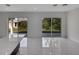 Living area with marble floors and sliding glass doors at 118 Green Pine Park, Rotonda West, FL 33947