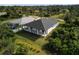Aerial view of the back of a house, featuring a patio area and green space at 118 Green Pine Park, Rotonda West, FL 33947
