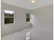Bright bedroom with two windows and marble-look floors at 118 Green Pine Park, Rotonda West, FL 33947