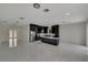 Modern kitchen with island, black cabinetry, and marble flooring at 118 Green Pine Park, Rotonda West, FL 33947