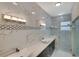 Spa-like bathroom with marble walls and double vanity at 118 Green Pine Park, Rotonda West, FL 33947