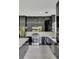 Modern kitchen with stainless steel appliances and black cabinetry at 118 Green Pine Park, Rotonda West, FL 33947