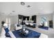 Open living room with white sofas and blue rug, showcasing kitchen and dining area at 118 Green Pine Park, Rotonda West, FL 33947