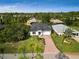 Aerial view of a single-Gathering home with a driveway and landscaped yard at 118 Green Pine Park, Rotonda West, FL 33947